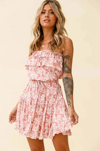 Detail of floral off-shoulder mini dress featuring ruffled neckline and waist tie string