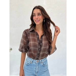 Detail of vintage brown plaid semi-sheer chiffon shirt with classic lapel and puff sleeves