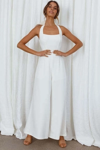 Detail of elegant white halter neck jumpsuit with wide-leg cut and cinched waist