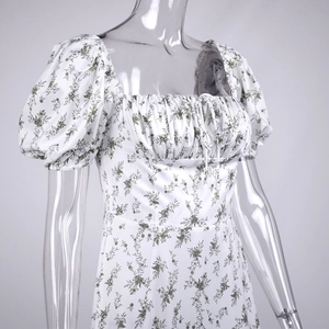Detail of square neckline with drawstring and puff sleeves on floral print dress