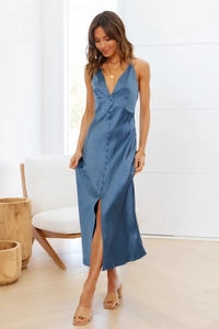 Detail of navy blue satin midi dress featuring a deep V-neck and row of elegant buttons