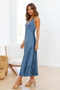 Detail of blue satin maxi dress featuring deep V-neckline and decorative front buttons
