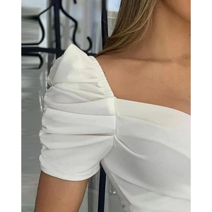 White V-neck puff sleeve blouse with pleated details and structural flare design