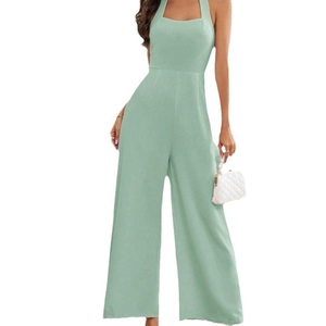 Elegant light green halter neck wide leg jumpsuit with sleeveless backless design