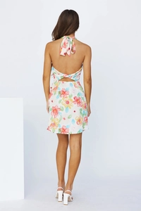 Close-up of the backless tie-neck design and colorful floral print on a mini dress
