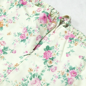 Detail view of floral midi dress showing the invisible zipper and elastic waist stitching