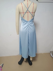 Detail of light blue satin dress featuring crisscross back straps and invisible zipper
