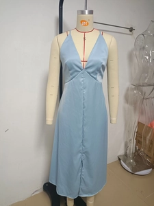 Detail of the light blue satin dress featuring a deep V-neck and a high front slit design