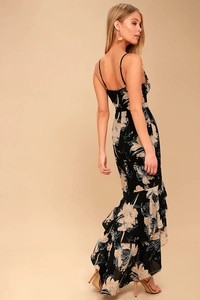 Detail of floral print maxi dress with tiered ruffle hem and fishtail silhouette