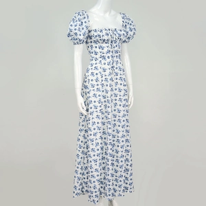 Detailed close-up of blue floral print on white puff sleeve dress with a square neckline
