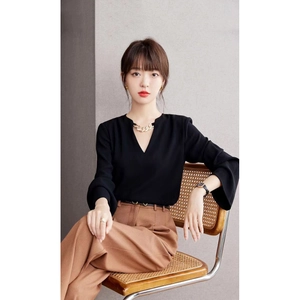 Elegant women's black V-neck chiffon shirt with chain detail and brown wide-leg pants