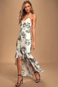 Detail of floral print on white sleeveless dress with ruffled irregular high-low hemline