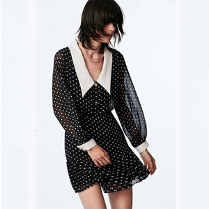 Polka dot chiffon dress with white pointed collar and pleated skirt detail