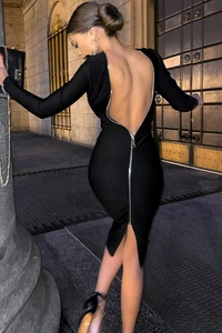 Detail view of the deep V-neck black dress with a striking long silver back zipper design