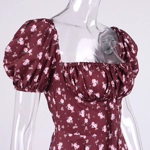 Detail view of wine red floral dress with puff sleeves and ruffled square neckline