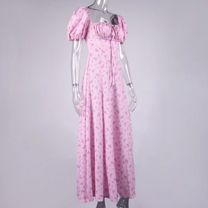 Close-up of pink floral summer dress featuring puff sleeves and drawstring bust detail
