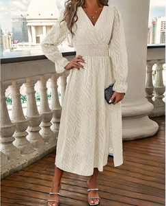 Detailed view of the V-neck and textured jacquard fabric on the off-white long sleeve dress