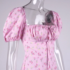 Close-up of pink floral dress featuring square neckline with drawstring and puff sleeves