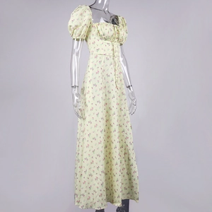 Detail of light yellow floral dress featuring puff sleeves and a ruffled bodice design