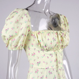 Detail of square neckline with lace-up tie and puff sleeves on floral dress