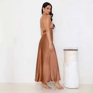 Detail view of the bronze satin maxi dress showing backless design with bow tie ribbon