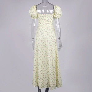 Detailed back view of floral maxi dress with square neck and zipper closure on yellow fabric