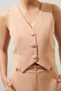 Detail der apricot-rosa Weste mit tiefem V-Ausschnitt und drei stoffbezogenen Knöpfen