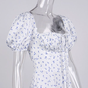Detail of square neck floral dress with smocked bodice and puff sleeves design
