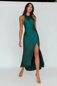Detailed view of the emerald green satin halter dress with side slit and waist pleats