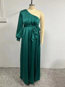 Elegant emerald green one-shoulder satin maxi dress with long puff sleeve and waist tie