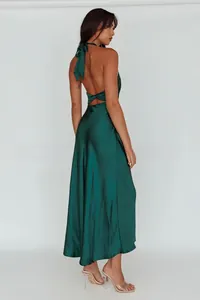 Detail of emerald green halter neck dress showing backless cut and twisted knot design