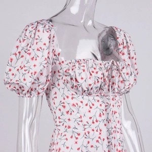 Detailed close-up of floral print puff sleeves and drawstring square neckline dress