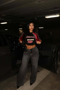 Detail of street style racing t-shirt with speedway studio graphic in urban parking lot