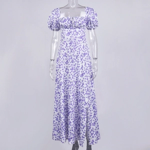 Detail view of square neckline with ruching and purple floral print on white summer dress