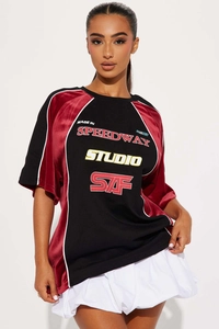 Detail of racing style women's t-shirt with velvet patchwork and speedway studio print