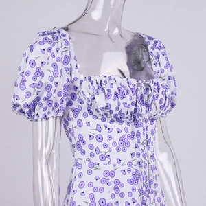 Detail of square neckline with drawstring and puff sleeves on floral dress