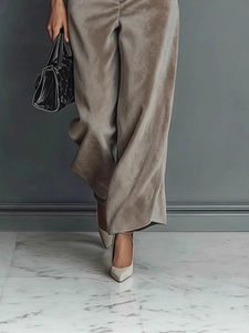 Detail showing the brown grey velvet wide-leg pants with high gloss and elegant drape