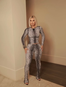 Close-up of sleek grey snakeskin print pattern on slim fit long sleeve top and pants