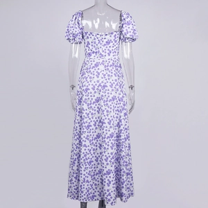 Back view of a white floral maxi dress with purple prints and elegant puff sleeves