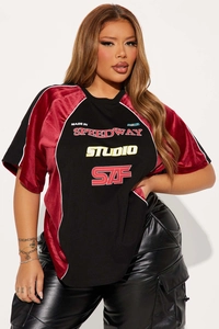 Detail of vintage racing T-shirt featuring velvet patchwork sleeves and letter prints