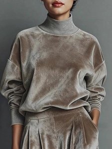 Close-up of premium velvet texture on a mock neck tracksuit with ribbed cuffs and hem