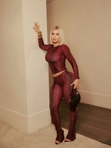 Detail of burgundy snakeskin print on tight long-sleeve top and leggings matching set