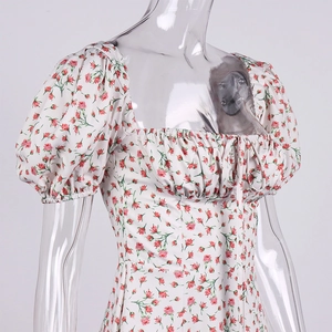 Close-up of the square neckline, puff sleeves, and red floral print on the summer dress