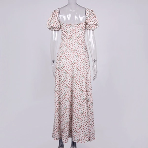 Back view of a white floral maxi dress featuring red prints and puff sleeves details