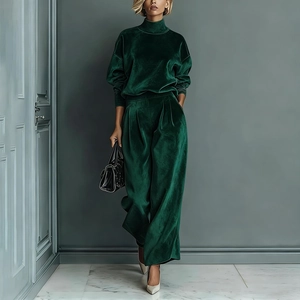 Detailed close-up showing the premium dark green velvet texture of the wide-leg trousers