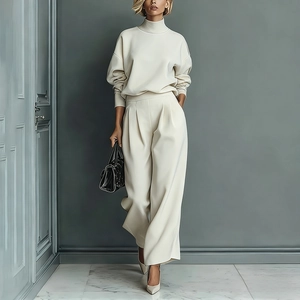 Fashionable cream velvet tracksuit featuring high-neck zipper top and wide-leg trousers