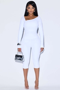 Detail of white two-piece slim set featuring an asymmetric neckline and high-elastic fabric