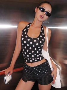 Chic black and white polka dot halter neck top with open back for a trendy summer look