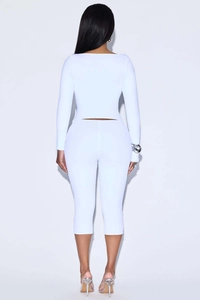 Rear view of white slim fit two-piece set featuring long sleeve top and capri pants