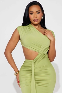 Detail of avocado green one-shoulder dress with ruched texture and waist cutout